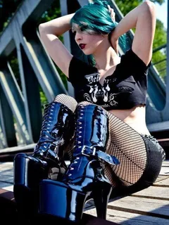 punk / goth chick in fishnets and high heel boots