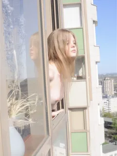 kisa showing her tits out a window