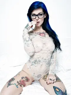 hot girl with tattoos and glasses in lingerie