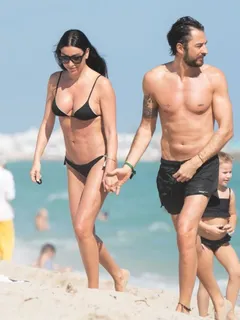 giorgia gabriele in a sexy little black bikini showing off her perfect model body and nice cleavage seen by paparazzi at the beach in miami.