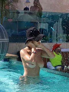 couple gettin handsy behind tao wickrath at the hotel pool